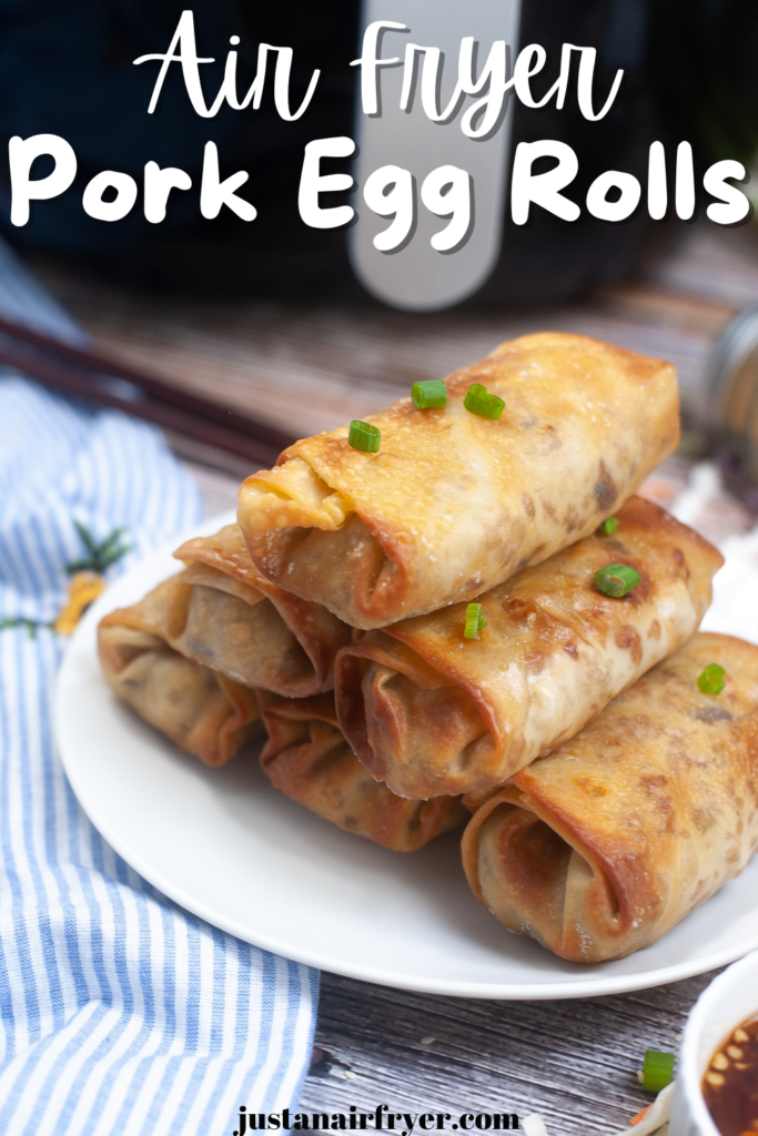 Title image for Air Fryer Pork Egg Rolls with a close up shot on a white plate with a blue striped towel