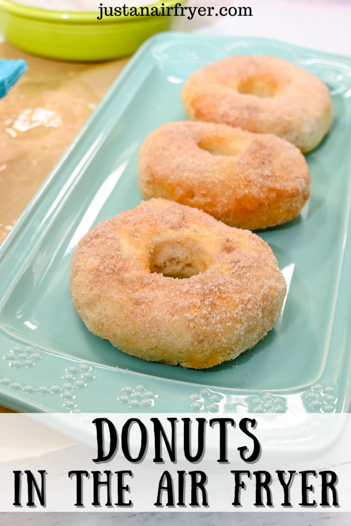 Sugar donuts on a pale blue platter for the title image