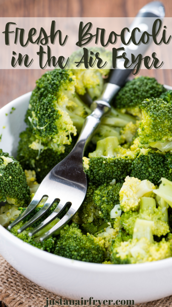 Close up image of Fresh Raw Broccoli in the Air Fryer in a white bowl with a fork in it. 