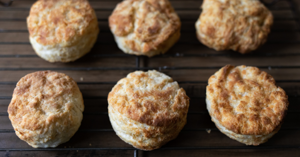 Six biscuits cooling on a rack. 