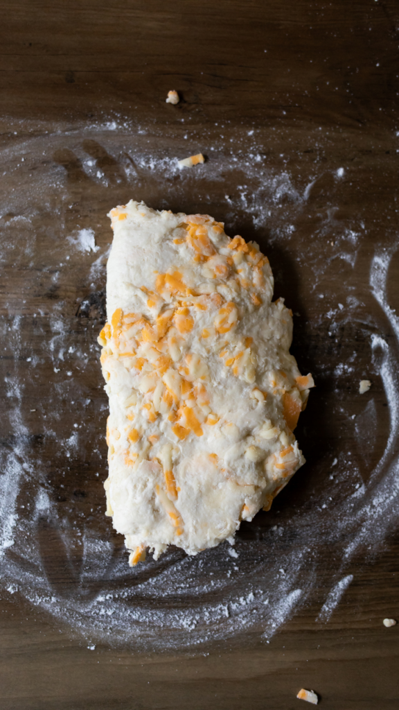 Folding over the cheddar biscuit dough. 