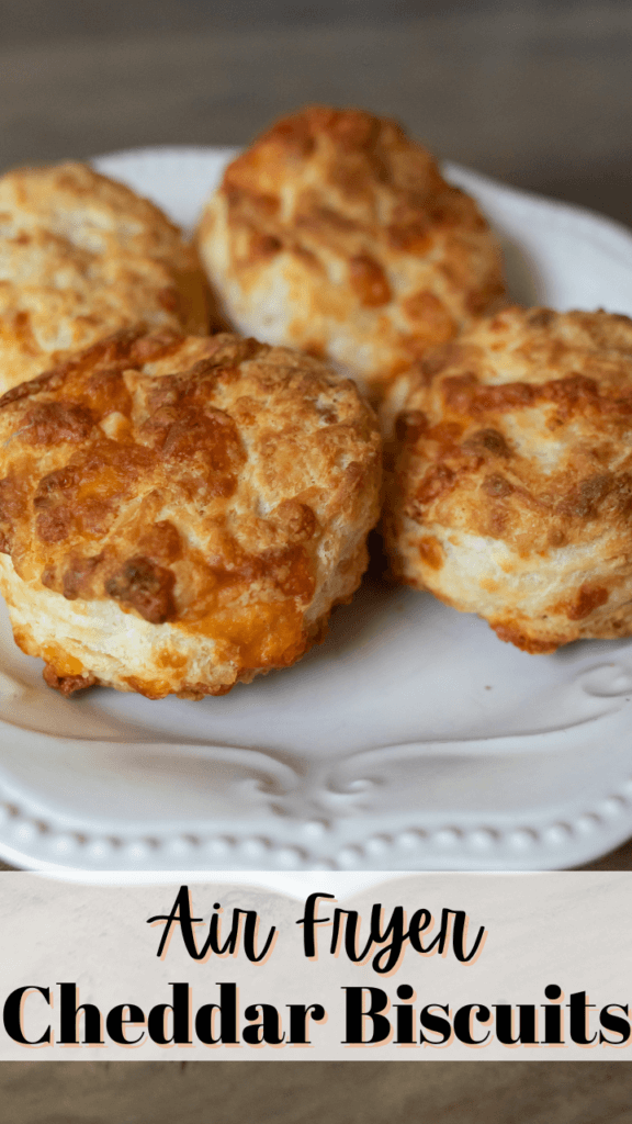Close up of cheddar biscuits on a white plate. 