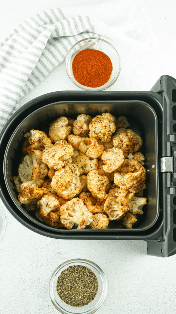 Cauliflower in the air fryer with spices on it. 