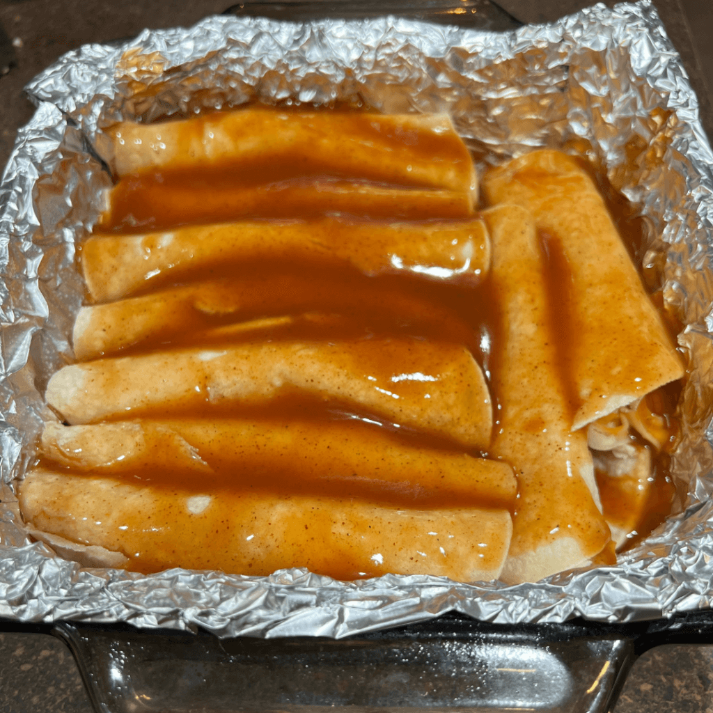 Cheese Enchiladas covered in red enchilada sauce. 