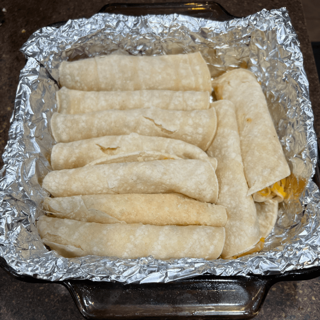 Cheese enchiladas ready for sauce. 