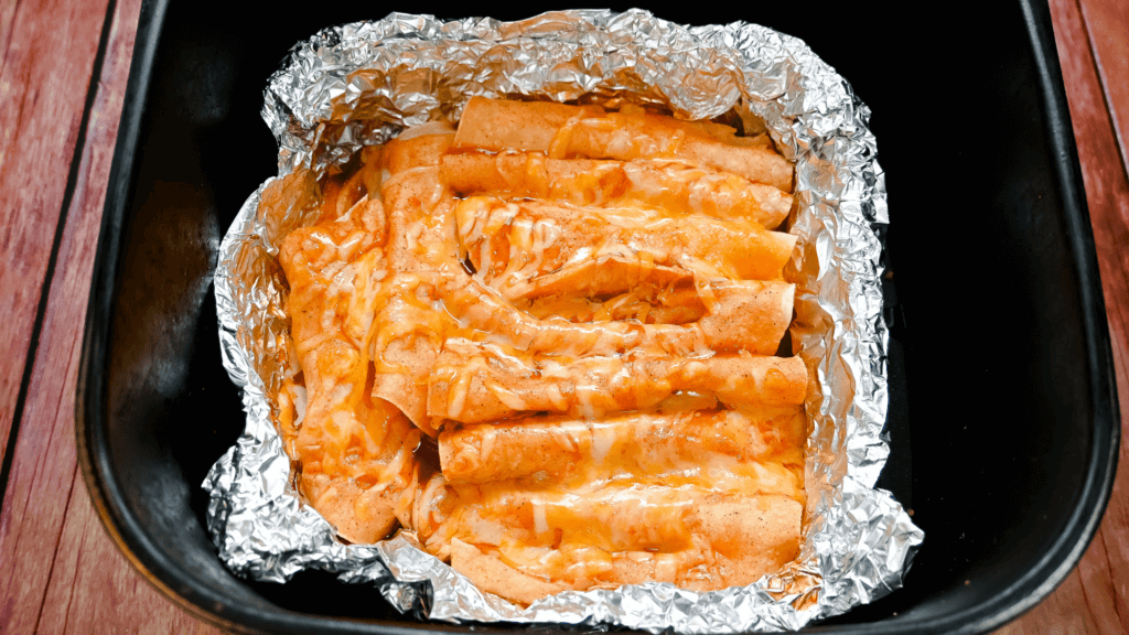 Cheese enchiladas ready to come out of the air fryer basket. 