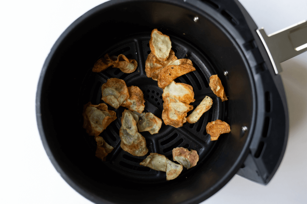 The potato chips in the air fryer after cooking