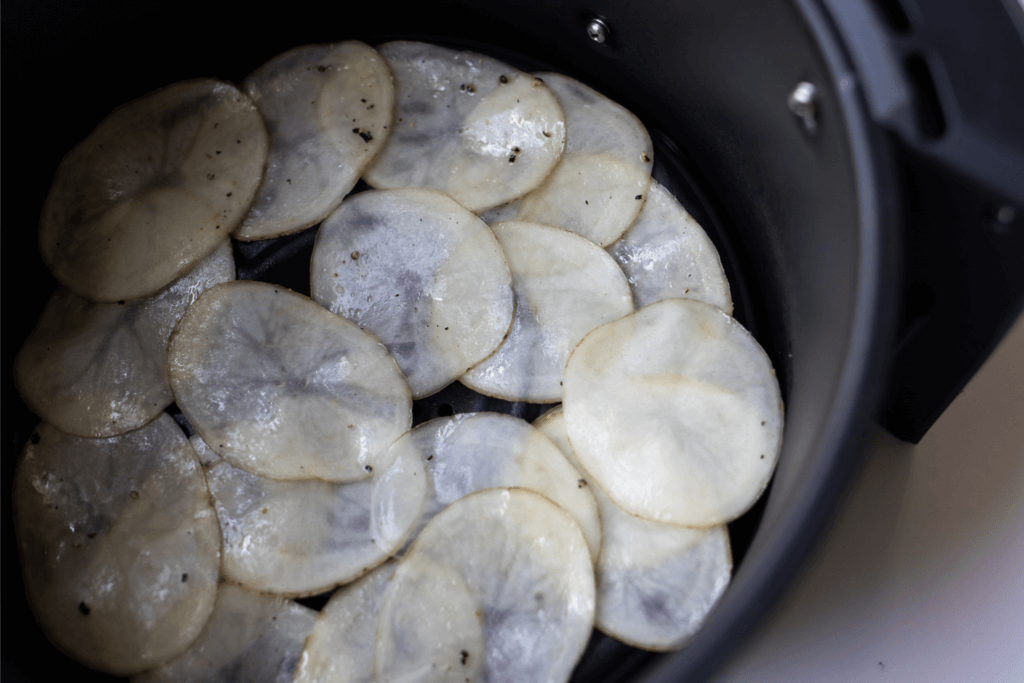 Laying the potato slices in the air fryer