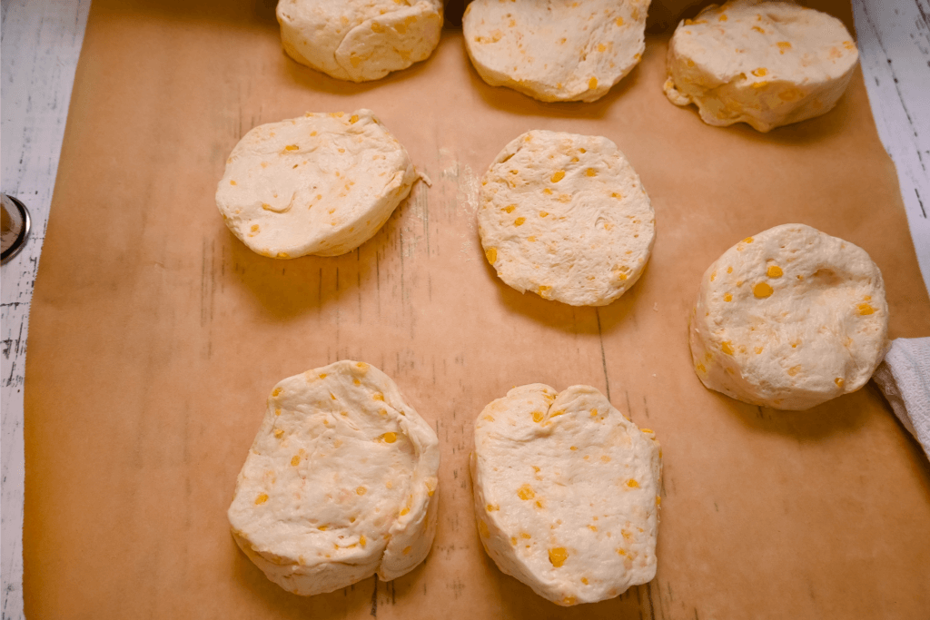The raw biscuits on brown parchment paper to be rolled out